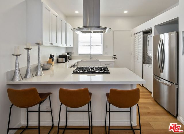 a kitchen with cabinets appliances a sink and a window