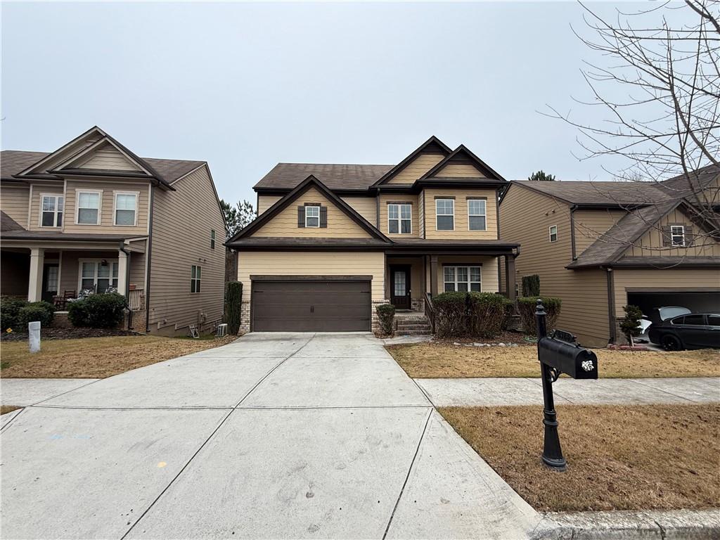 a front view of a house with yard and parking