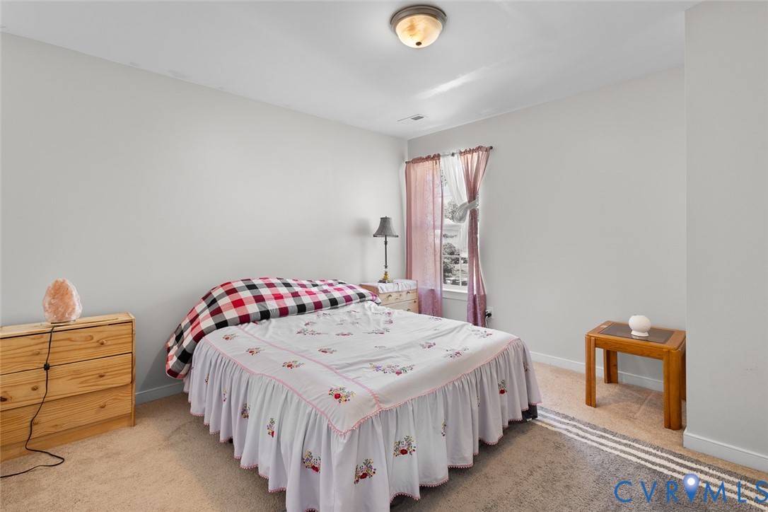 10155 Virginia Road Glen Allen, VA 23060 - Photo 15 of 34 Bedroom with light colored carpet and baseboards