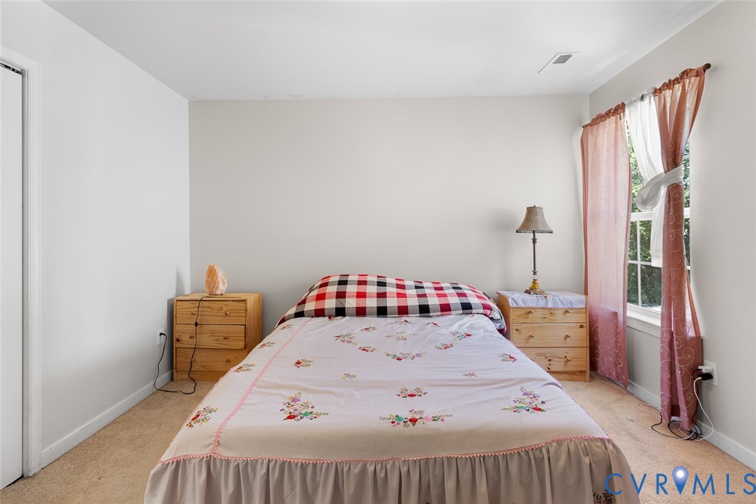 10155 Virginia Road Glen Allen, VA 23060 - Photo 16 of 34 Bedroom featuring light carpet and baseboards
