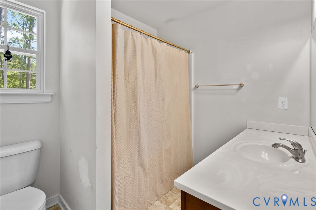 10155 Virginia Road Glen Allen, VA 23060 - Photo 19 of 34 Bathroom with vanity and a shower with shower curt