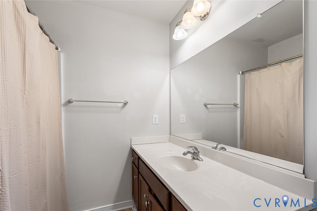 10155 Virginia Road Glen Allen, VA 23060 - Photo 20 of 34 Bathroom with vanity and a shower with curtain