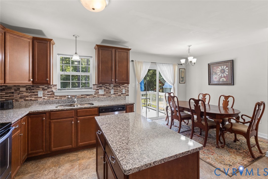 10155 Virginia Road Glen Allen, VA 23060 - Photo 7 of 34 Kitchen with backsplash, light stone counters, a c