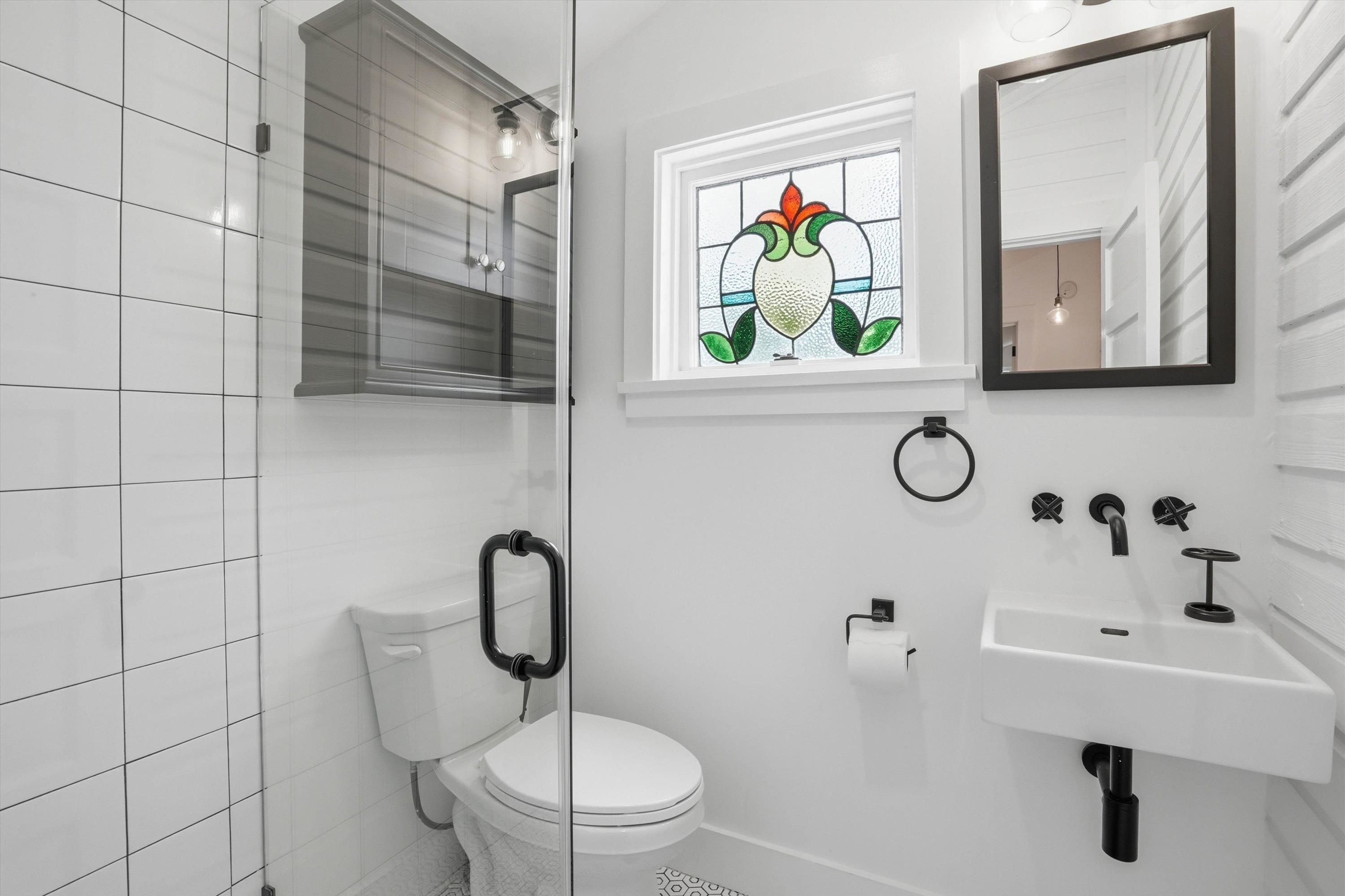 76 Oneida Street St. Augustine, FL 32084 - Photo 19 of 38 a bathroom with a toilet sink and mirror