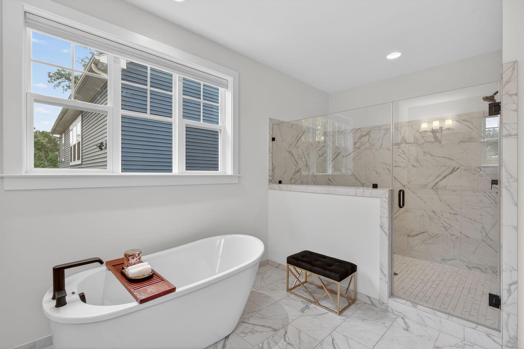 6213 Mcconnell Lane Springfield, VA 22152 - Photo 21 of 39 a bathroom with a tub a window and a glass door shower