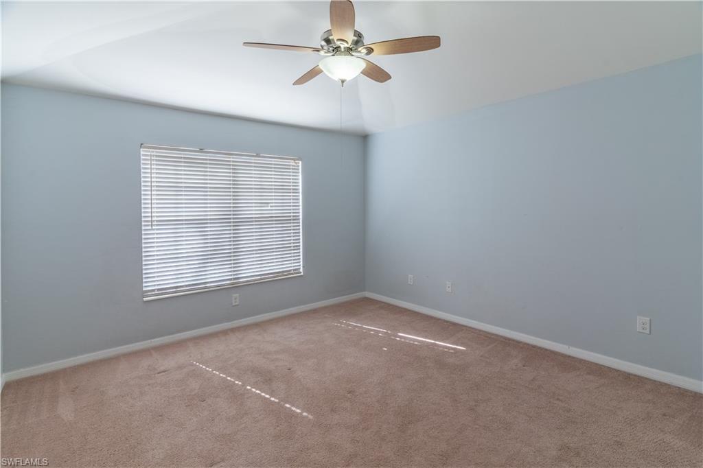16146 Caldera Lane, Unit 31 Naples, FL 34110 - Photo 14 of 35 an empty room with a window and a fan