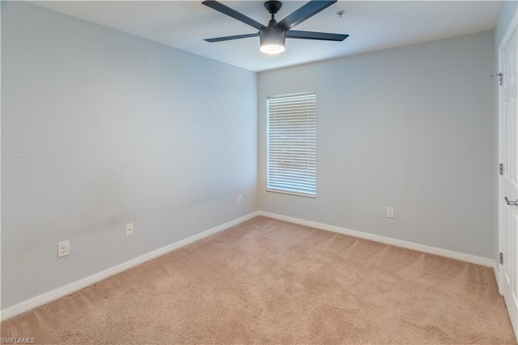 16146 Caldera Lane, Unit 31 Naples, FL 34110 - Photo 18 of 35 an empty room with a window and a fan