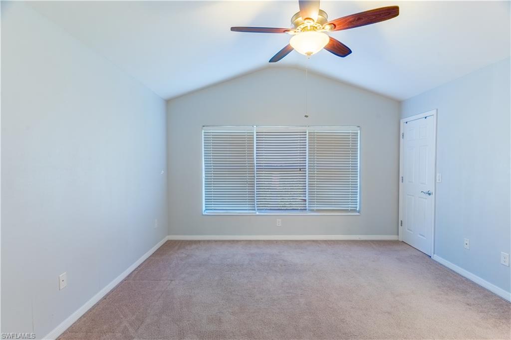16146 Caldera Lane, Unit 31 Naples, FL 34110 - Photo 21 of 35 an empty room with windows and chandelier fan