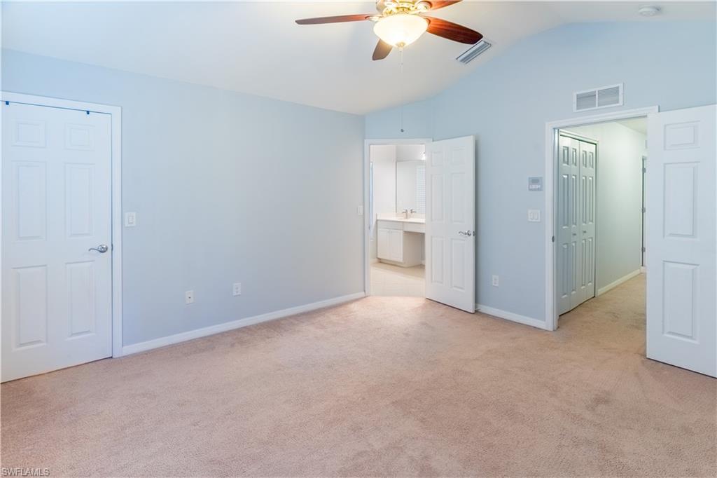 16146 Caldera Lane, Unit 31 Naples, FL 34110 - Photo 22 of 35 an empty room with chandelier fan