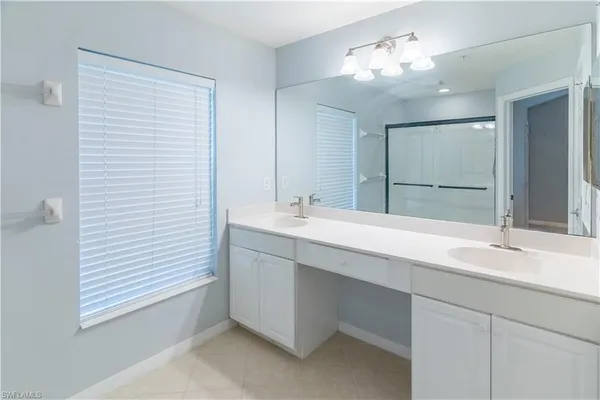a bathroom with a glass shower door