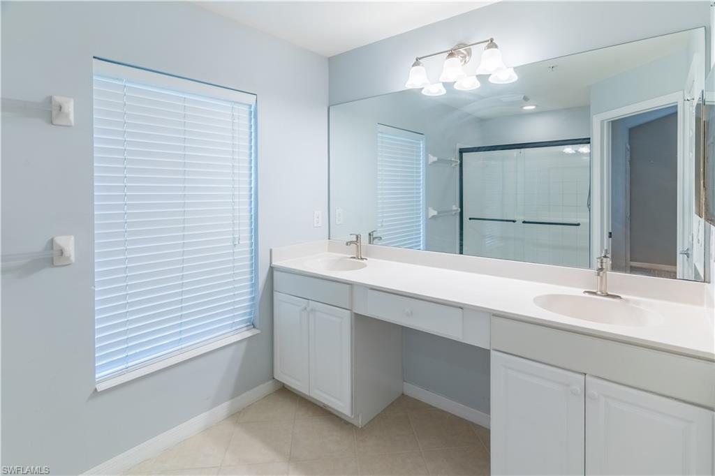 16146 Caldera Lane, Unit 31 Naples, FL 34110 - Photo 24 of 35 a bathroom with a sink and a mirror
