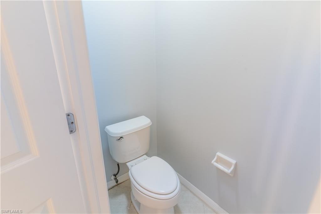 16146 Caldera Lane, Unit 31 Naples, FL 34110 - Photo 26 of 35 a white toilet sitting next to a white wall