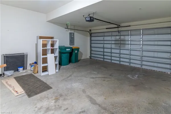 a view of a livingroom with a ceiling fan and refrigerator