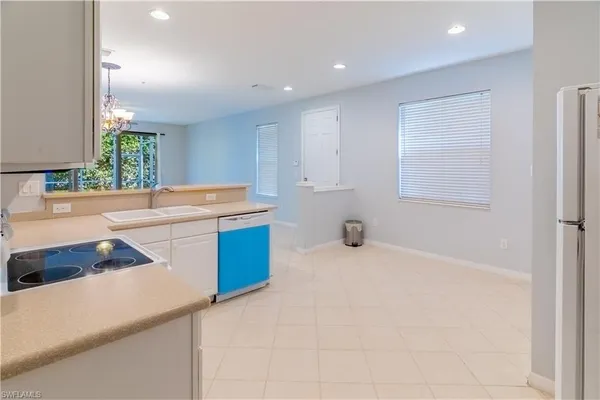 a kitchen that has a sink and a stove in it