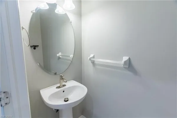 a bathroom with a sink and mirror
