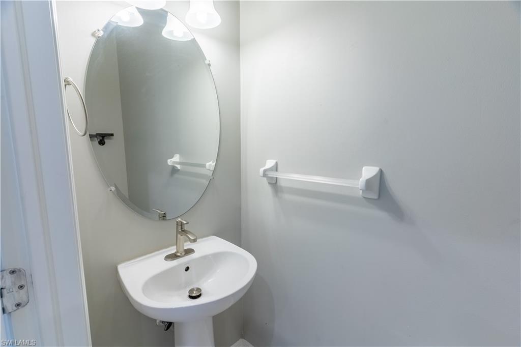 16146 Caldera Lane, Unit 31 Naples, FL 34110 - Photo 10 of 35 a bathroom with a sink and mirror