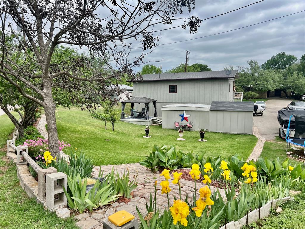309 Broken Arrow Comanche, TX 76442 - Photo 12 of 35 a view of a backyard with couches and plants