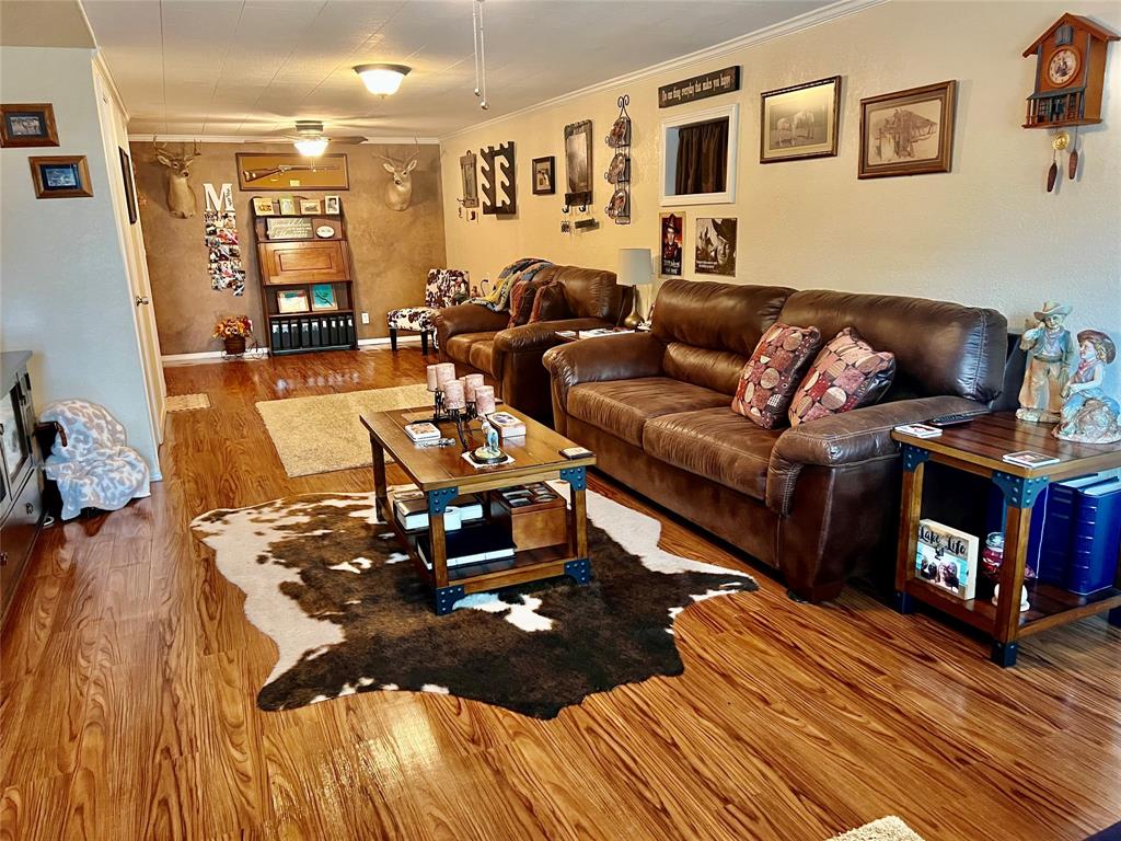 309 Broken Arrow Comanche, TX 76442 - Photo 16 of 35 a living room with furniture and wooden floor