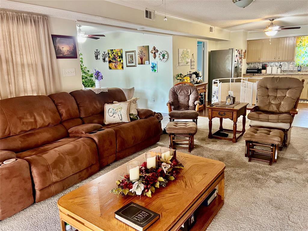 309 Broken Arrow Comanche, TX 76442 - Photo 21 of 35 a living room with furniture and a dining table with wooden floor