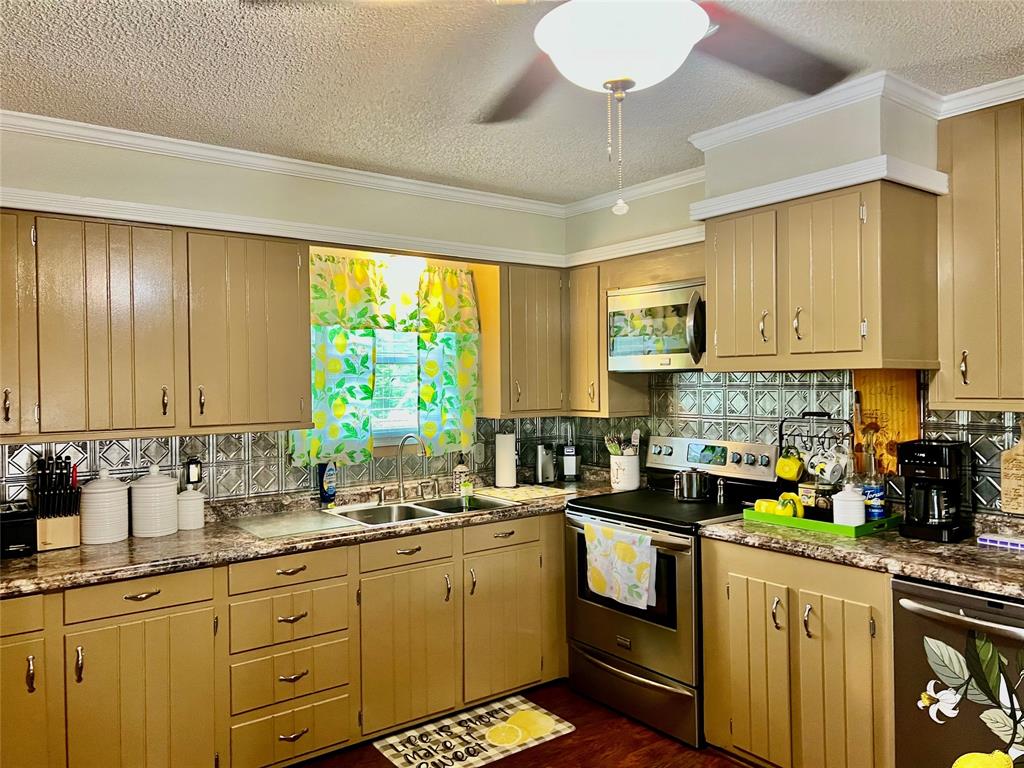 309 Broken Arrow Comanche, TX 76442 - Photo 23 of 35 a kitchen with a sink stove and microwave