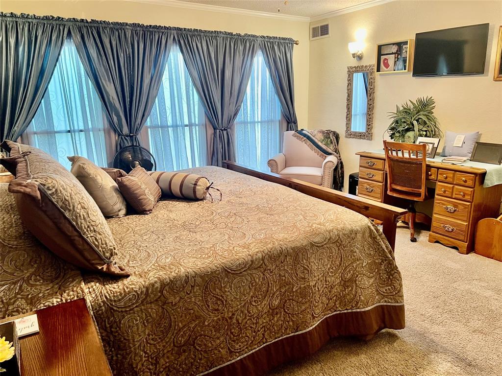 309 Broken Arrow Comanche, TX 76442 - Photo 26 of 35 a bed sitting in a bedroom next to a window