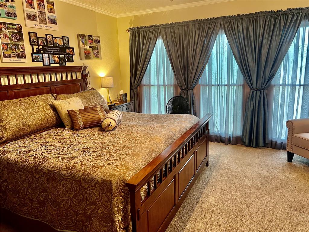 309 Broken Arrow Comanche, TX 76442 - Photo 27 of 35 a bedroom with a bed and a baby crib