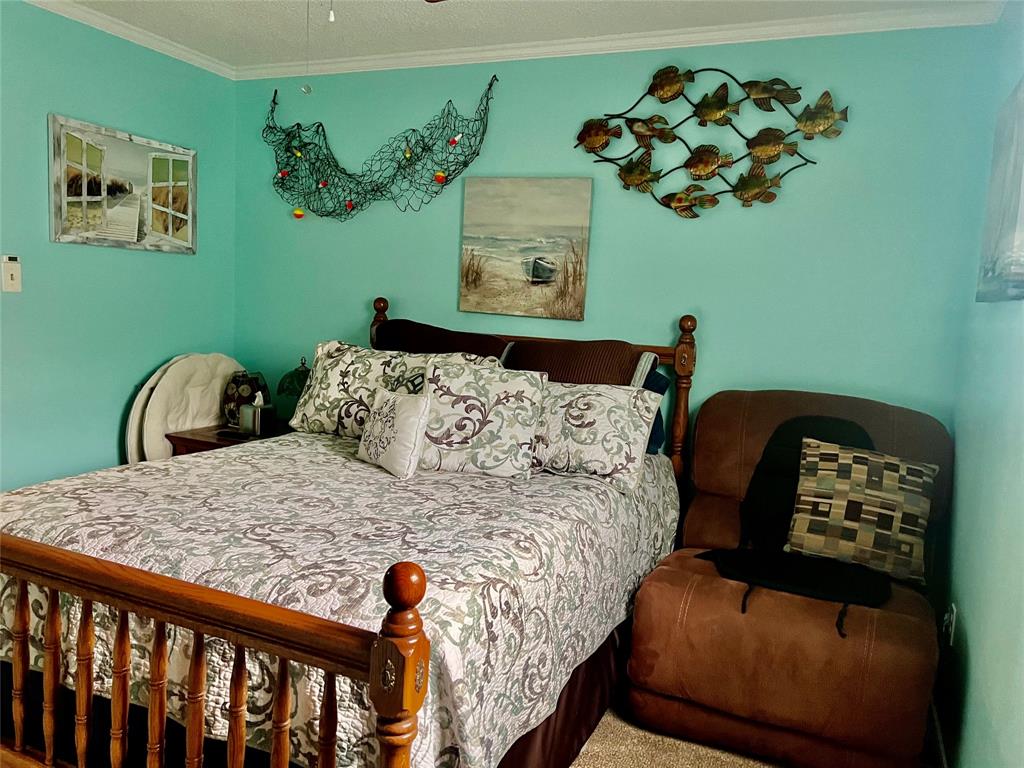 309 Broken Arrow Comanche, TX 76442 - Photo 31 of 35 a bedroom with a bed and a painting on the wall