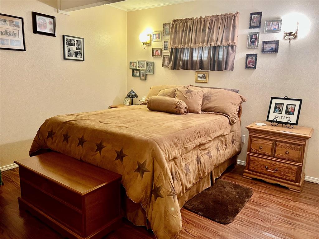 309 Broken Arrow Comanche, TX 76442 - Photo 32 of 35 a bedroom with a bed and a night stand