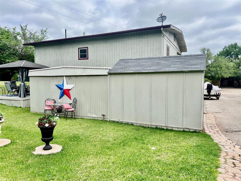 309 Broken Arrow Comanche, TX 76442 - Photo 10 of 35 a view of a house with garden