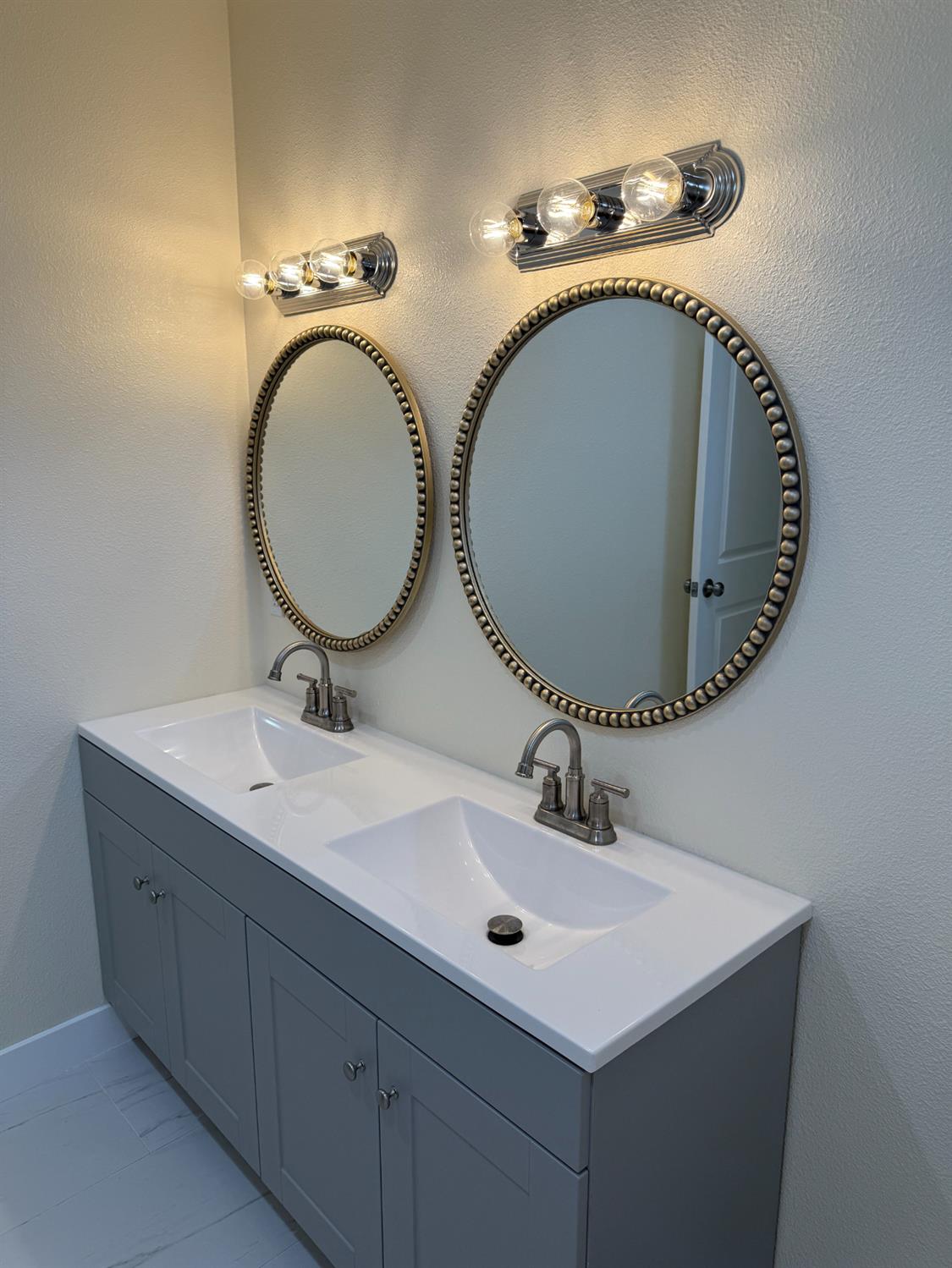 1098 East 21st Street Merced, CA 95340 - Photo 14 of 23 a bathroom with a sink and a mirror