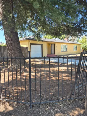 a backyard of a house with barbeque oven