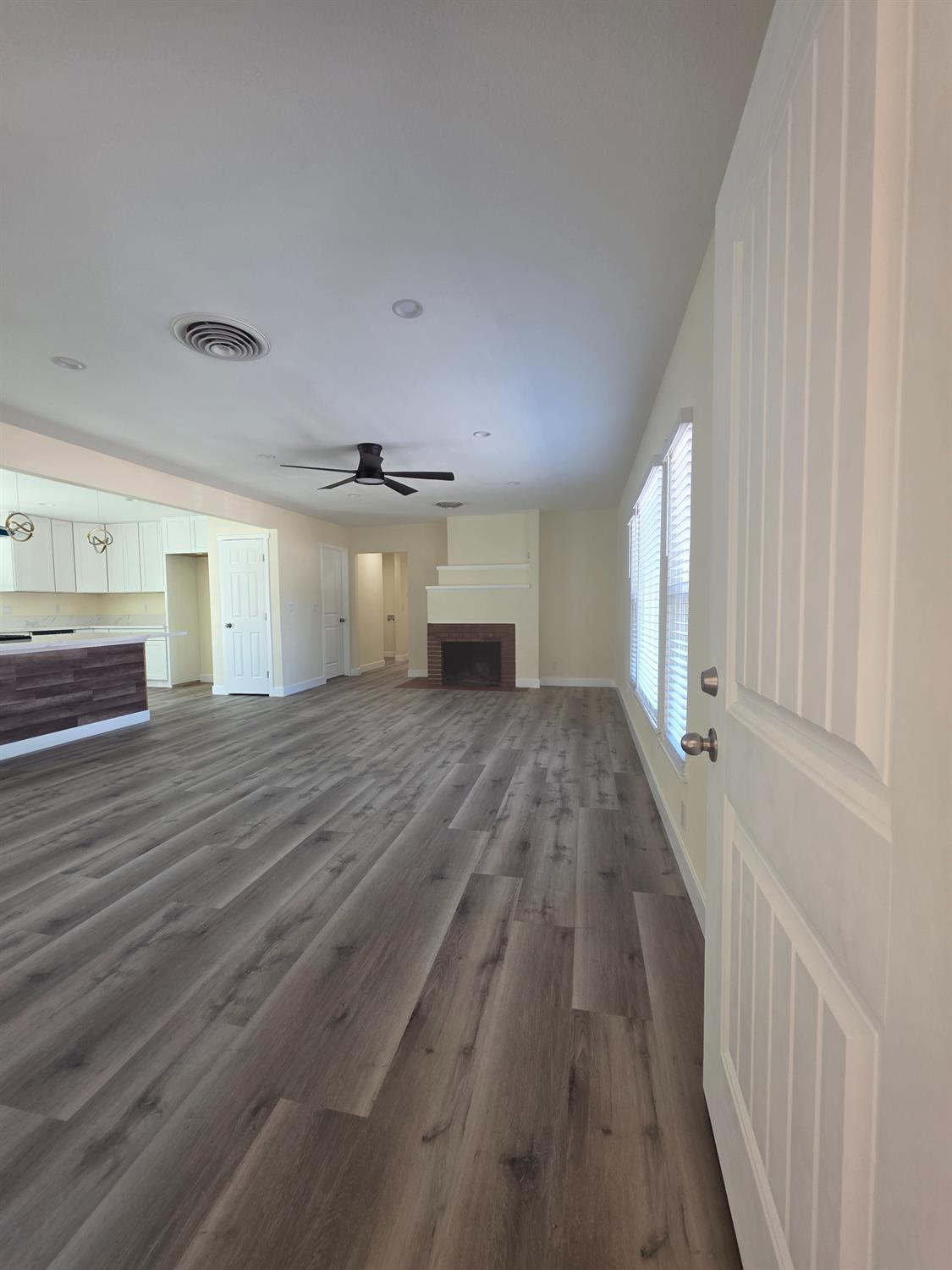 1098 East 21st Street Merced, CA 95340 - Photo 5 of 23 wooden floor in an empty room with a window