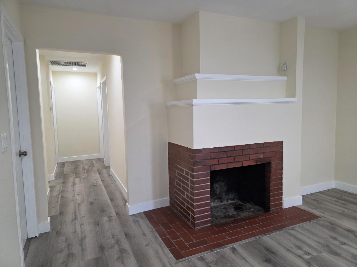 1098 East 21st Street Merced, CA 95340 - Photo 6 of 23 a living room with a fireplace and wooden floor
