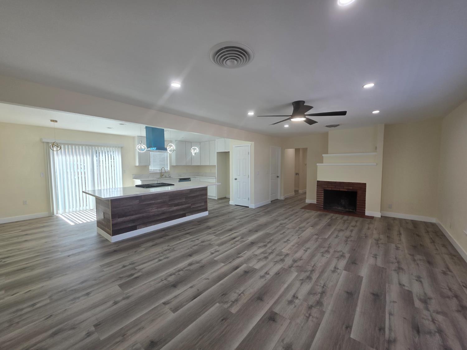 1098 East 21st Street Merced, CA 95340 - Photo 7 of 23 a spacious bedroom with a bed and a chandelier