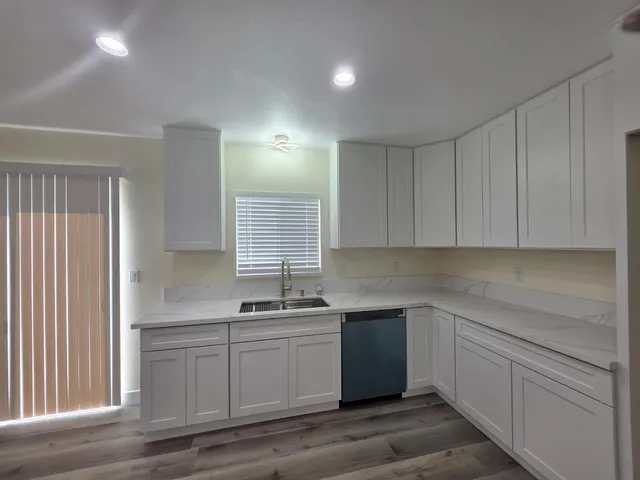 a kitchen with a sink cabinets and window