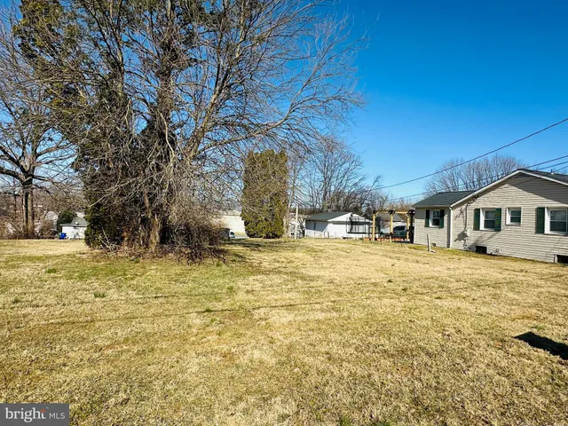 a yellow house with trees in front of it