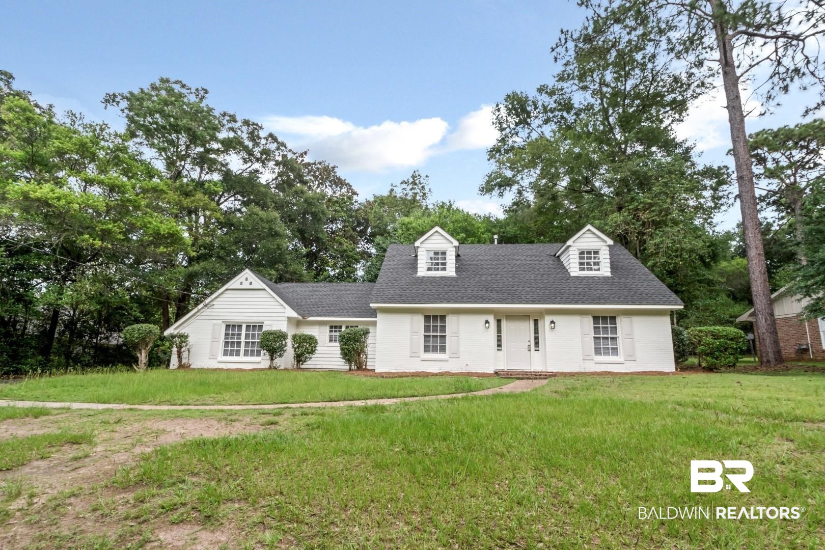 810 Nassau Drive Mobile, AL 36608 - Photo 28 of 31 New england style home featuring a front lawn, roof with shingles, and view of scattered trees