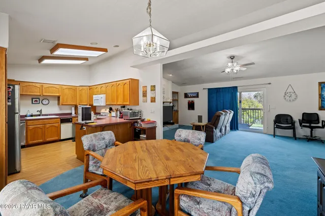 a living room with fireplace furniture and a chandelier