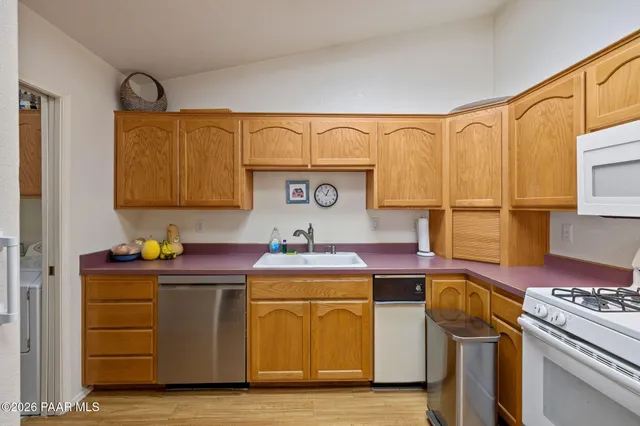 a kitchen with a stove top oven sink and cabinets