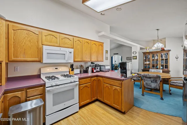 a utility room with wooden floor and cabinet