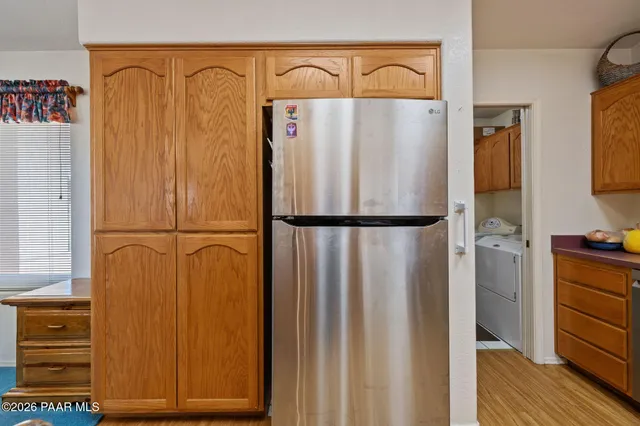 a view of washer and dryer with kitchen view