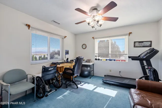 a view of a livingroom with workspace and a window