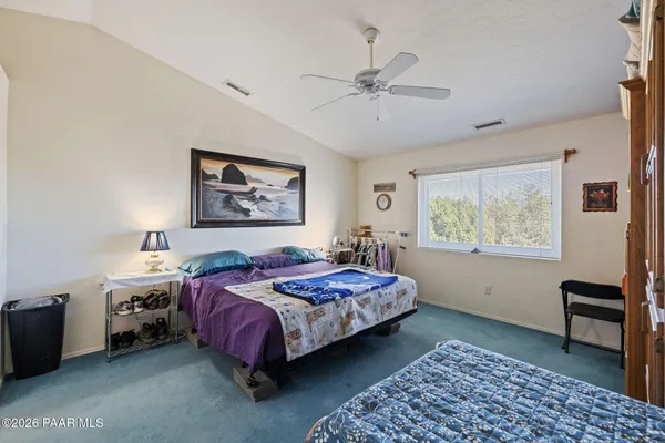 a bedroom with a bed and a chair