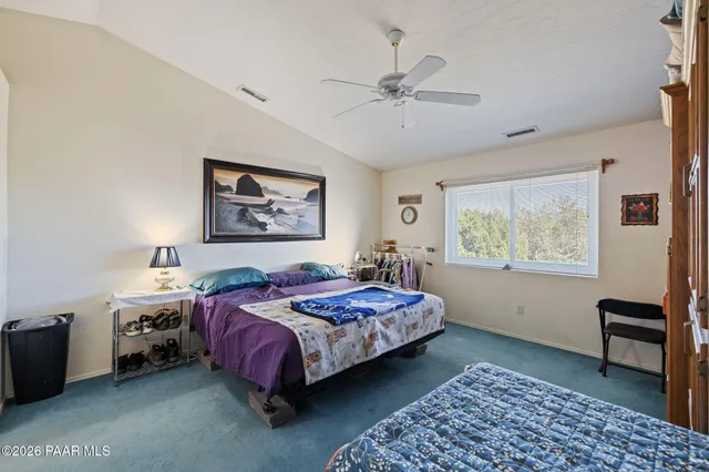 a bedroom with a bed and a chair