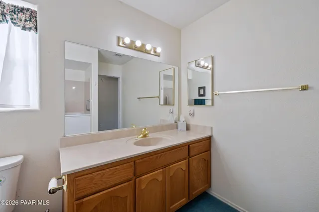 a bathroom with double vanity sink and mirror
