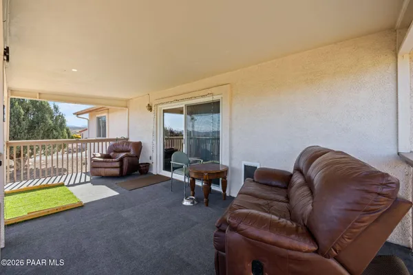 a living room with furniture kitchen view and a table