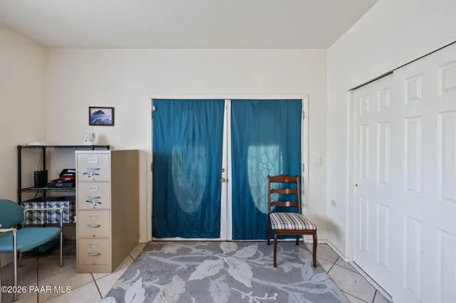 a living room with furniture ceiling fan and a wooden floor