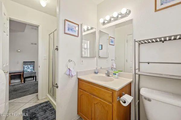 an aerial view of a house with a yard and mountain view in back