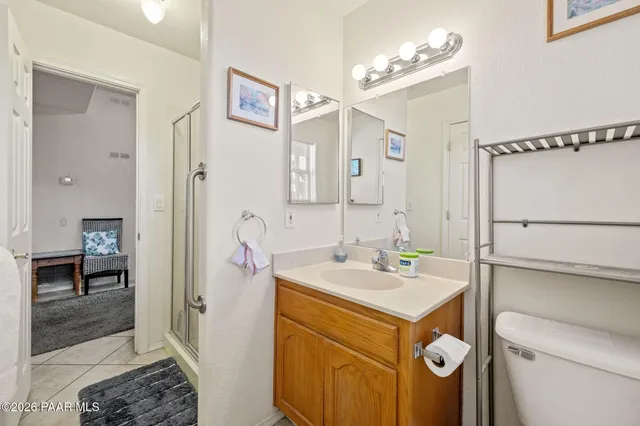an aerial view of a house with a yard and mountain view in back
