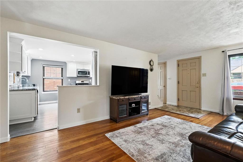 616 Highview Road Pittsburgh, PA 15234 - Photo 9 of 35 a living room with furniture and a flat screen tv